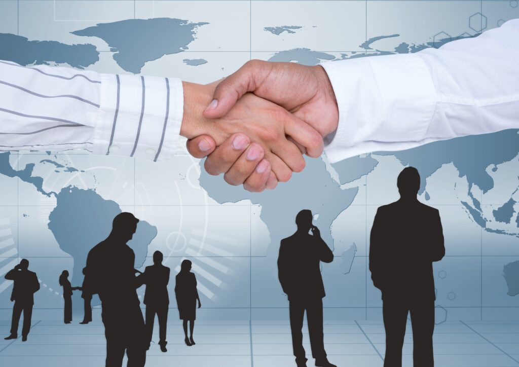 Representational Image of Businesspeople shaking hands against map background image of businesspeople shaking hands against map background