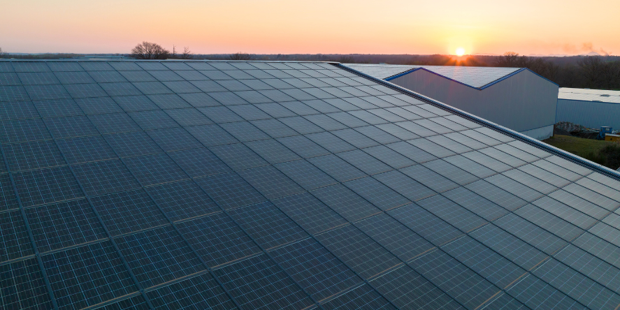 blue photovoltaic solar panels mounted building roof producing clean ecological electricity sunset production renewable energy concept. Image courtesy: FreePik, by bilanol