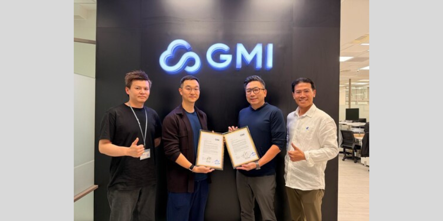 Four individuals pose in front of a GMI logo, holding signed documents as part of a collaboration announcement between Compal and GMI Cloud. Image Courtesy-GMI Cloud
