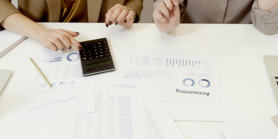 Two Accounting professionals analyzing financial documents with a calculator. Image Courtesy-Artem Podrez from Pexels